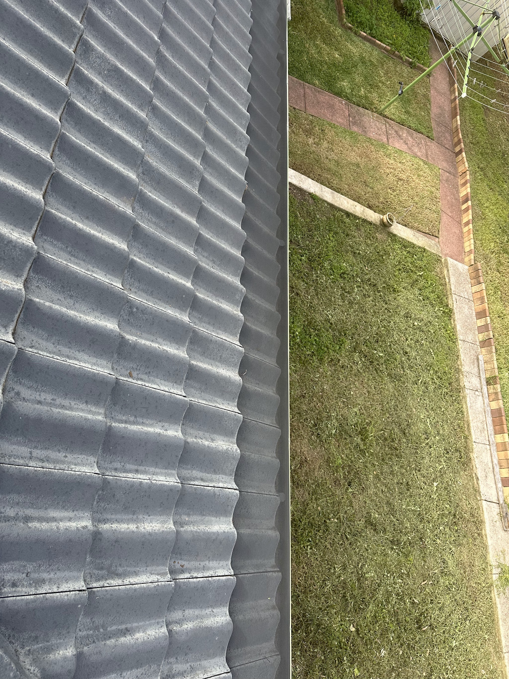 Close-up of coated roof tiles beside a view down to the backyard